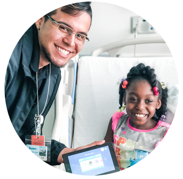 Young child smiling with student teacher