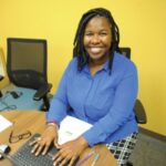 student smiling at computer