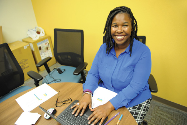 woman smiling with hands on keyboard