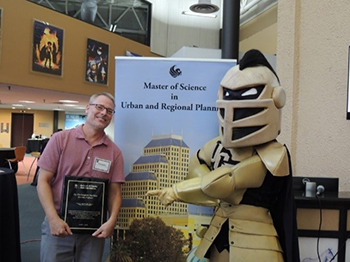 Dr. Christopher Hawkins accepting an award