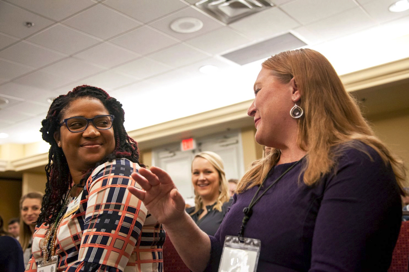 Conference attendees conversing.