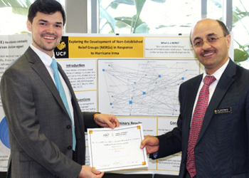 Naim Kapucu holding award with student