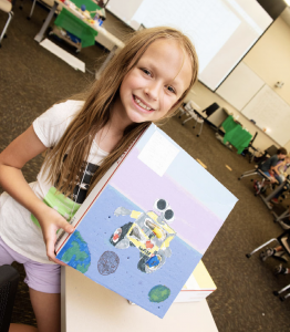 child holding painting