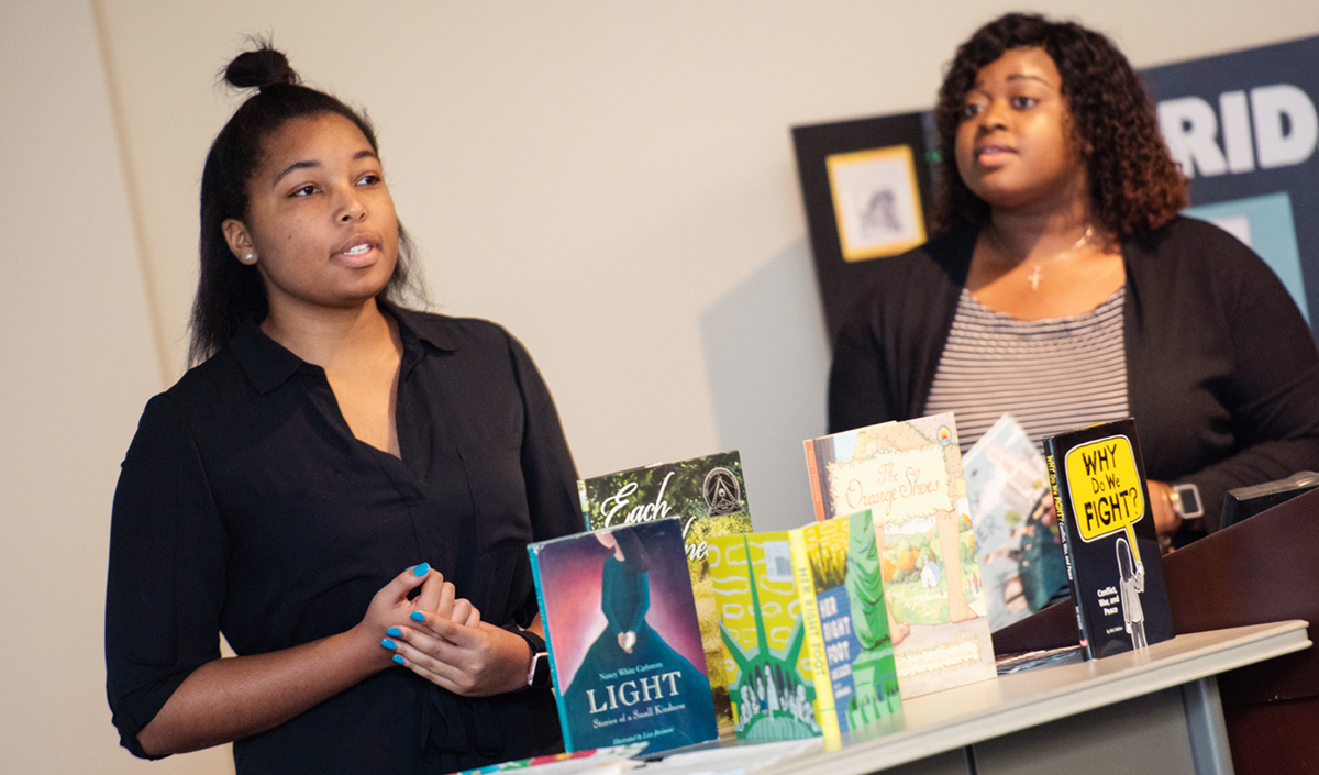 women displaying books