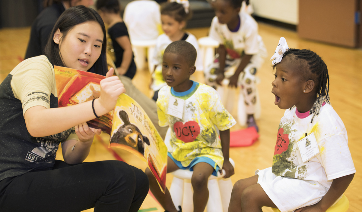 teacher sharing book with children