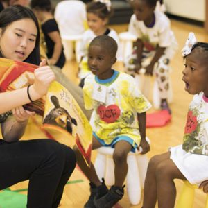 teacher sharing book with children