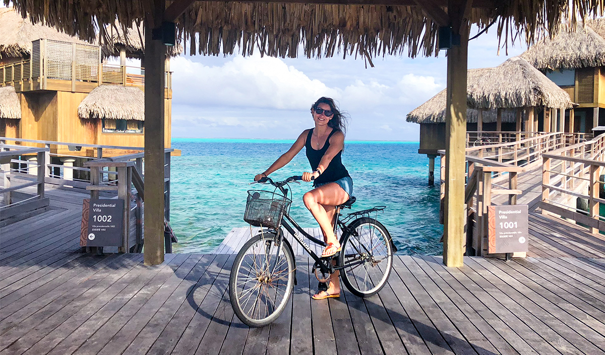 woman on bicycle on overwater deck