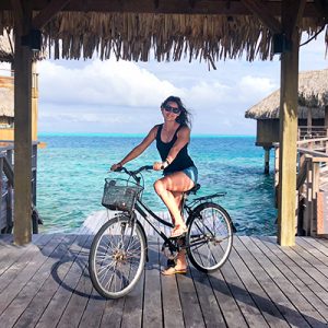woman on bicycle on overwater deck