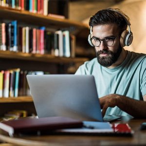 man with headphones on laptop