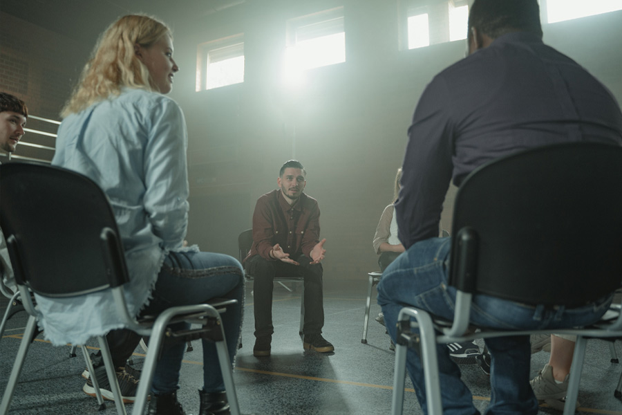 man speaking at support group