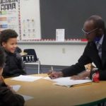 man teaching child