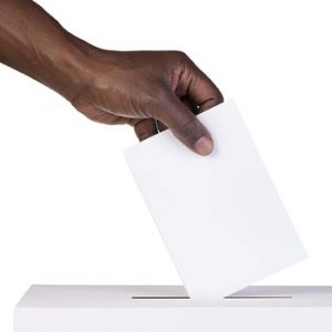 hand dropping ballot in box
