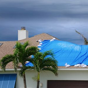 blue tarp on roof of house