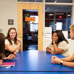 UCF counselor education students discuss coursework around a table