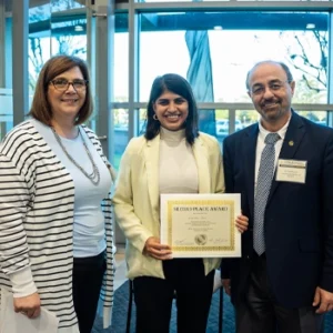 Erin Blackwell and Naim Kapucu with UCF student holding award