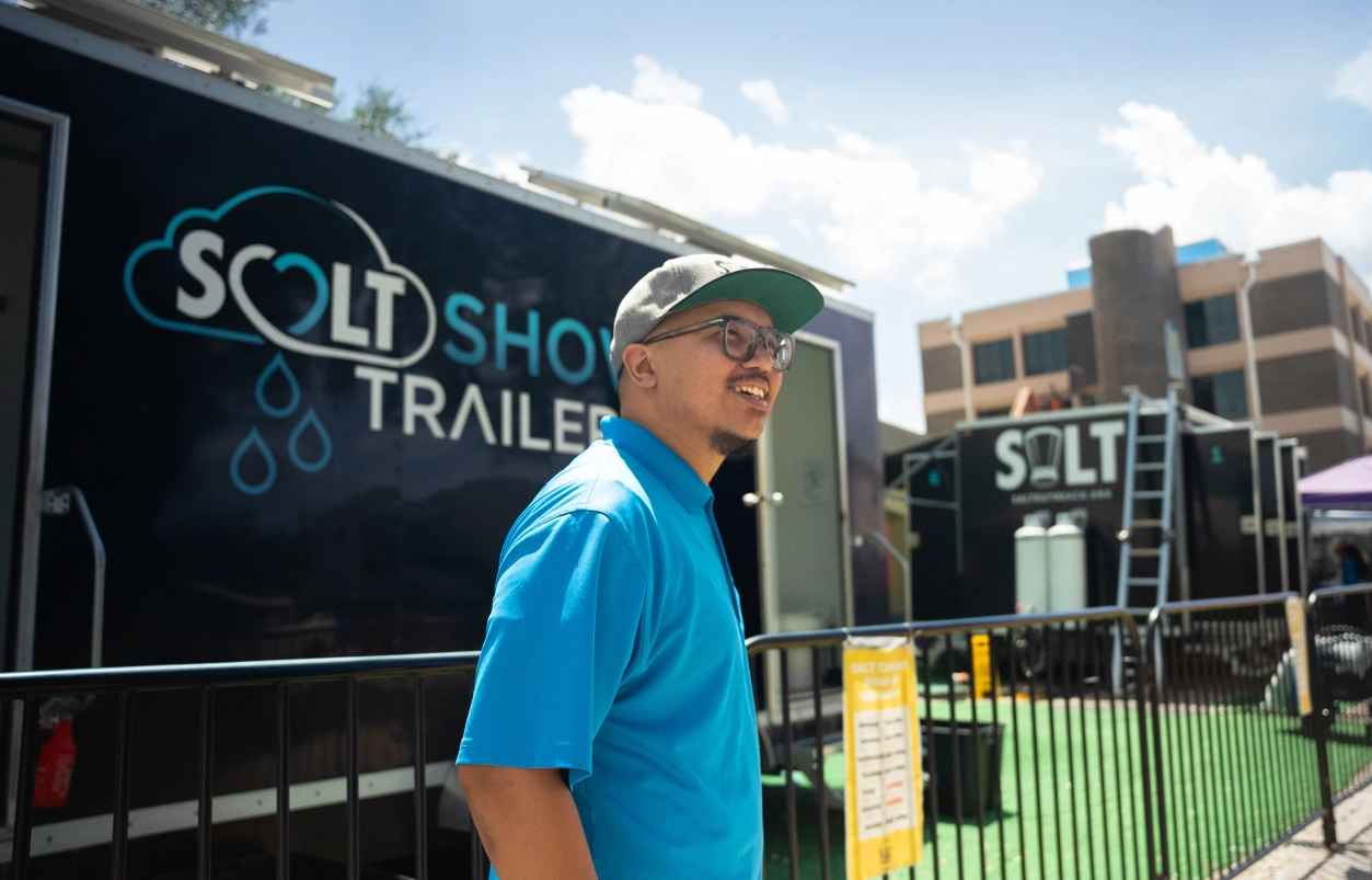 man smiling in front of trailer