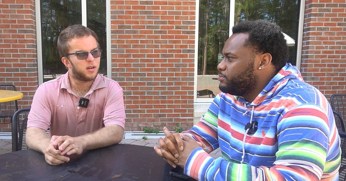 Two men sitting at a table having a discussion