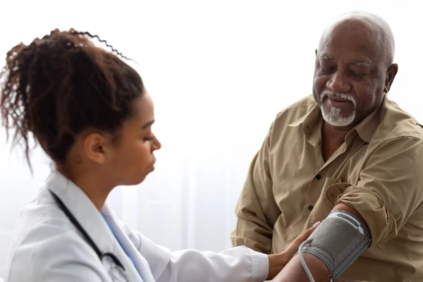 Healthcare worker taking patient's blood pressure