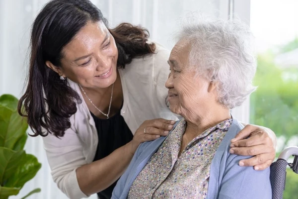 Healthcare work and elderly patient in wheelchair