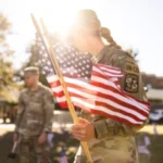 woman in military uniform holding american flag