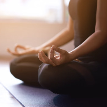 woman sitting in yoga meditation pose