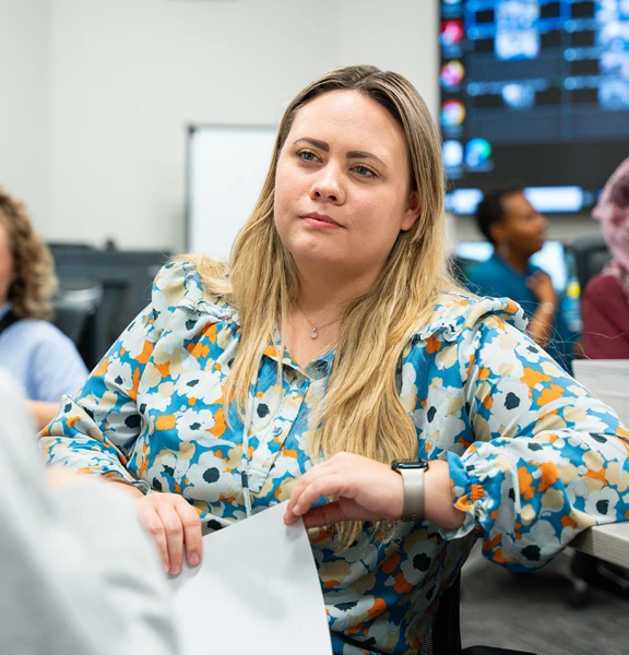 woman holding papers while in conversation