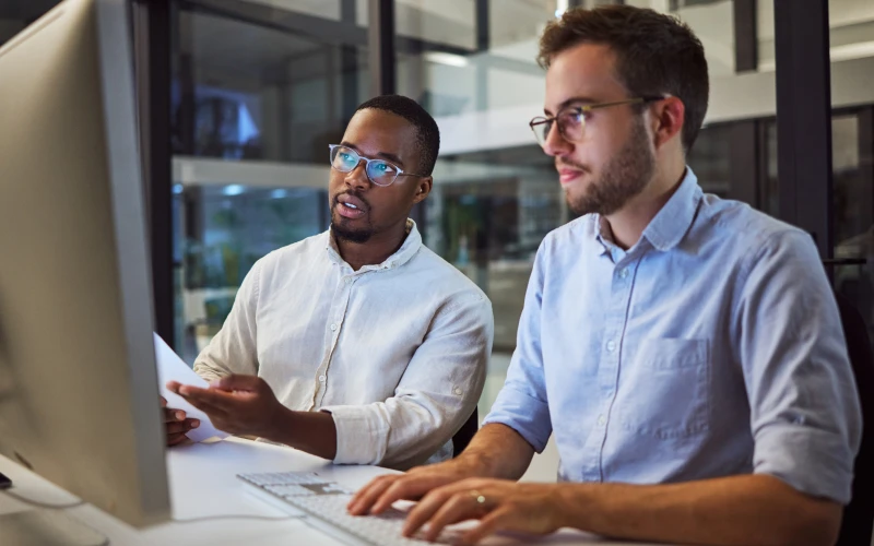 Two researchers looking at computer screen