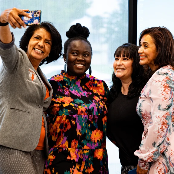 Four ladies taking a group selfie photo
