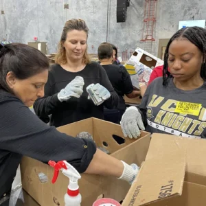 Three female students organizing boxes
