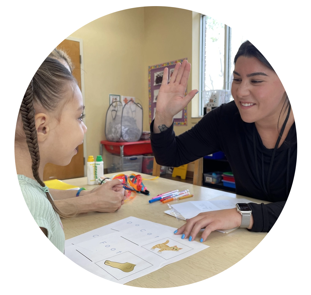 Student teacher interacting with child student