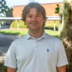 Nathan Kehoe standing outside in front of a tree