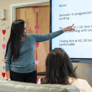 Sejal Barden pointing to screen during presentation