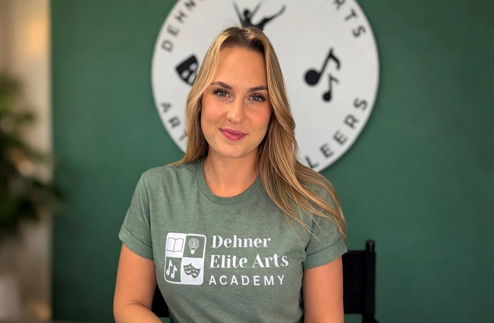 Mary Annaliese Dehner-Muniz smiling in a Dehner Elite Arts Academy shirt