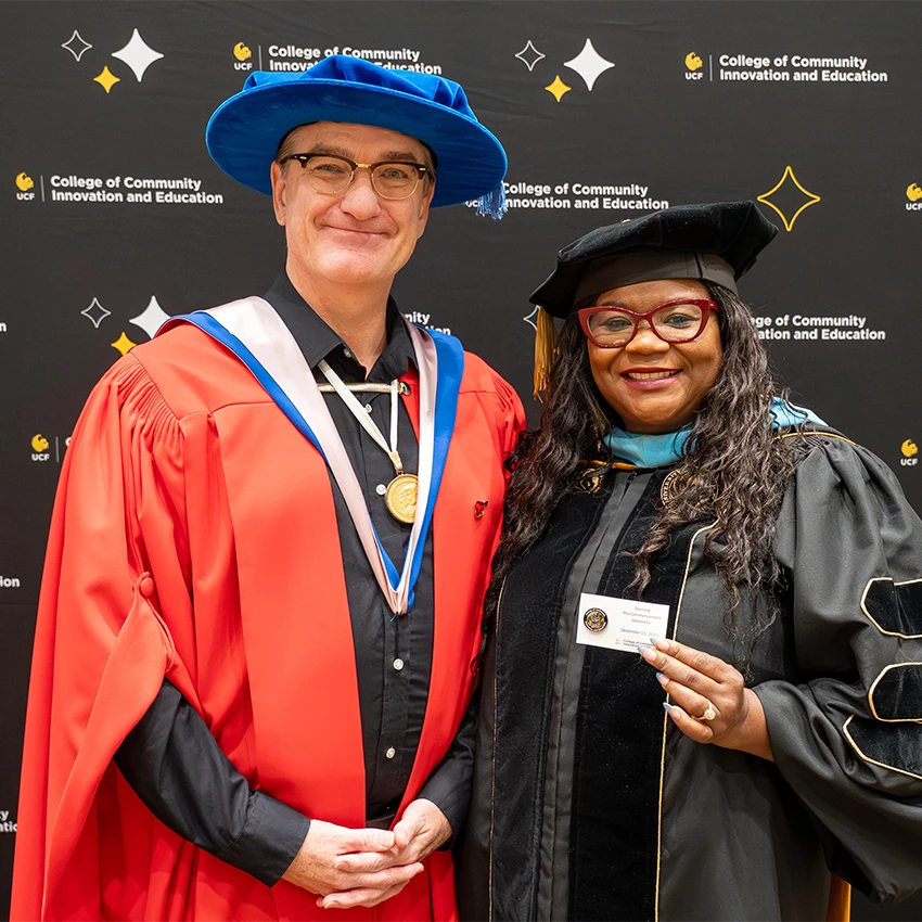 CCIE Professor and Graduate in graduation attire