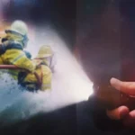 hand holding flashlight on firefighters in action