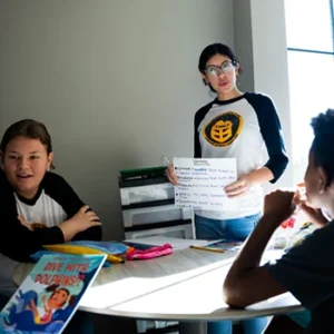 Two UCF teacher education students working with two children on vocabulary and reading